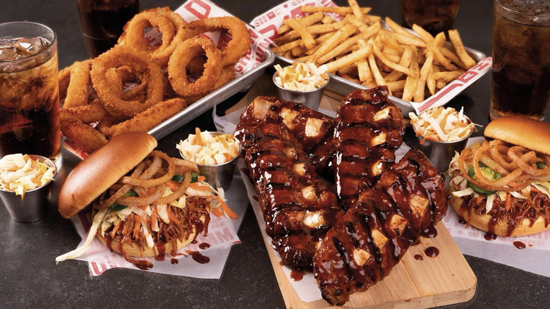 Carious plates of Applebee's food on black table