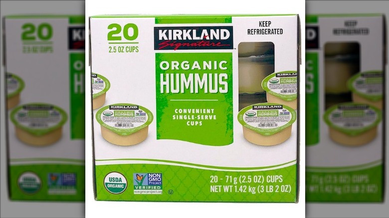 A box of 20 Kirkland Signature Organic Hummus single-serve tubs on a white background.