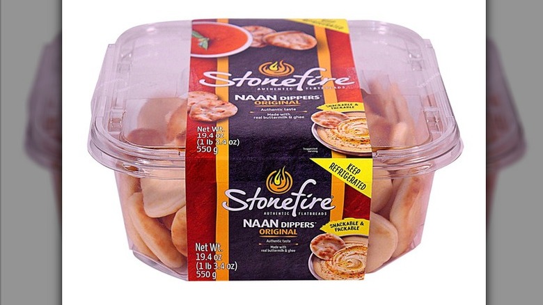 A clear plastic tub of Stonefire Naan Dippers on a white background.