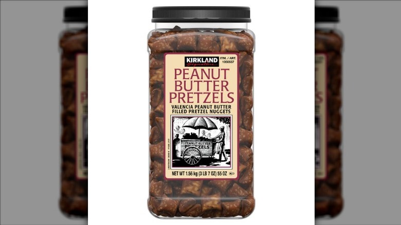A jar of Kirkland Signature Peanut Butter Pretzels on a white background.