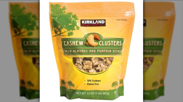 A bag of Kirkland Signature Cashew Clusters on a white background.