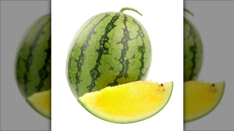 A watermelon with yellow flesh on a white background.