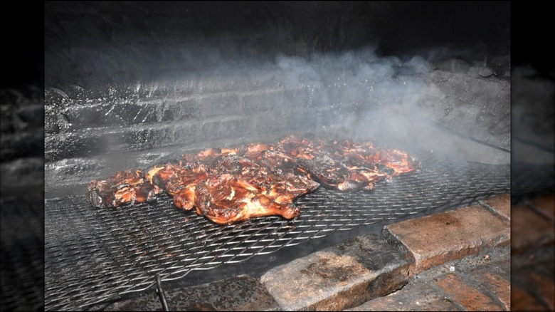 Miss Myra's half chickens being smoked on the grill