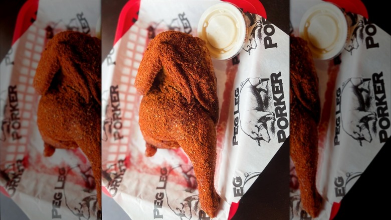 Basket of dry rub half-chicken with sauce from Peg Leg Porker