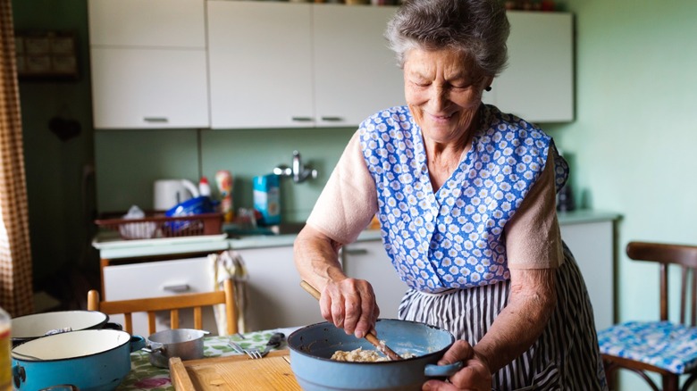 An older woman or grandmother baking in her kitchen