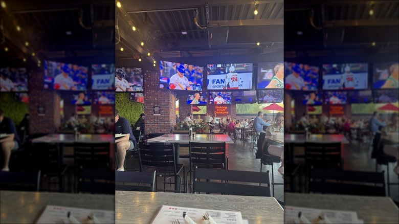 The outdoor patio at K O'Donnell's; people seated at tables with TVs playing sports