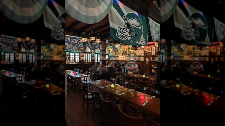 The interior of McGillin's in the daytime with Philadelphia Eagles banners hanging from ceiling