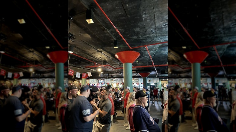 The Bullpen bar; large, crowded, with low black ceilings and large green and red pillars