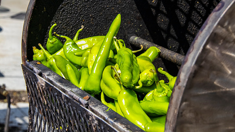Green chiles in a roaster.
