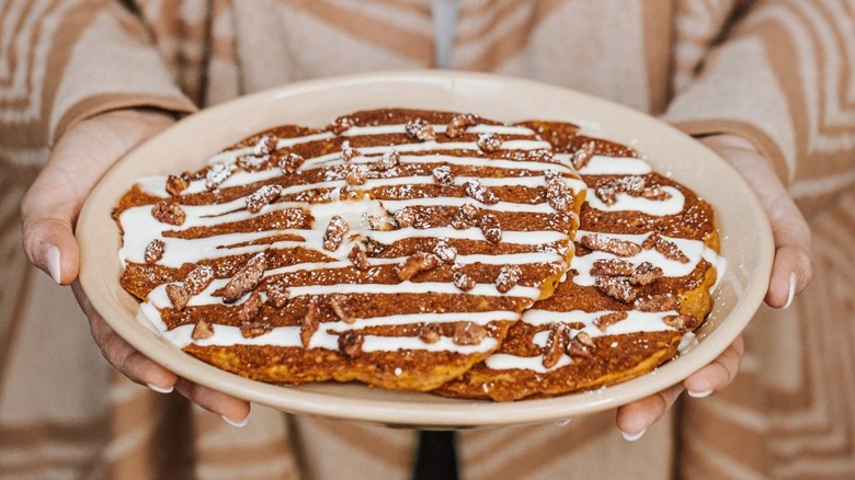 Large pancakes with icing and nuts