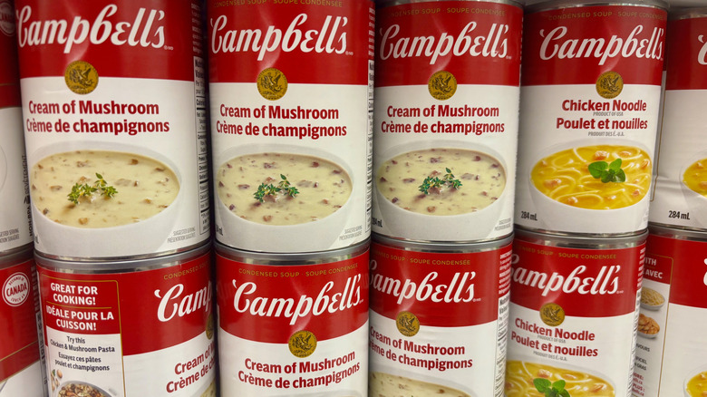 Cans of various Campbell's soup in rows, including chicken noodle and cream of mushroom.