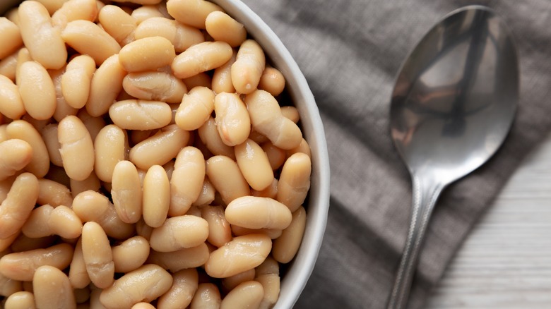 Cannellini beans in white bowl with spoon