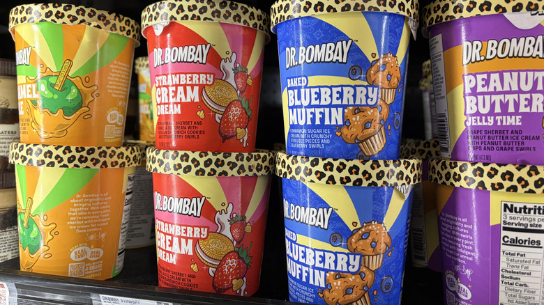 Orange, red, blue, and purple containers of Dr. Bombay ice cream on store's freezer shelf