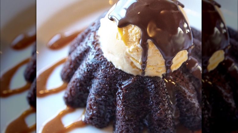 A chocolate lava cake topped with ice cream.