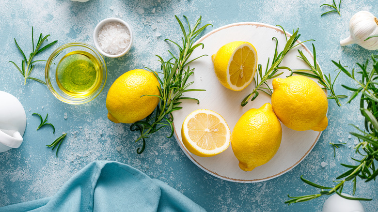 lemon and rosemary with salt on blue surface