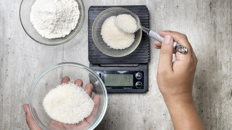 person weighing ingredients on scale