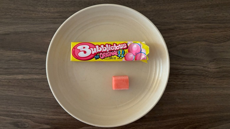 Bubblicious Chewing Gum and pieces of gum on round beige plate