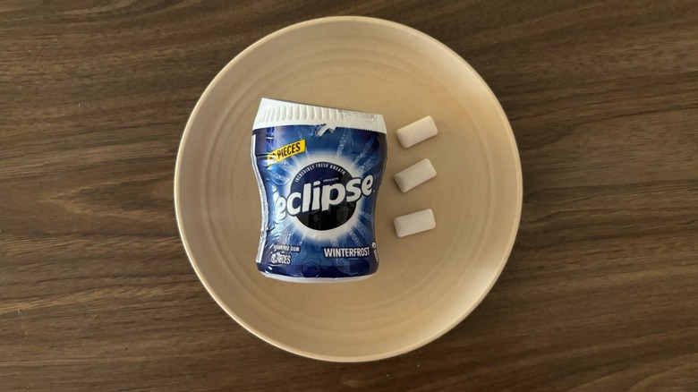 Eclipse Winterfrost Sugarfree Gum packaging and pieces of gum on round beige plate