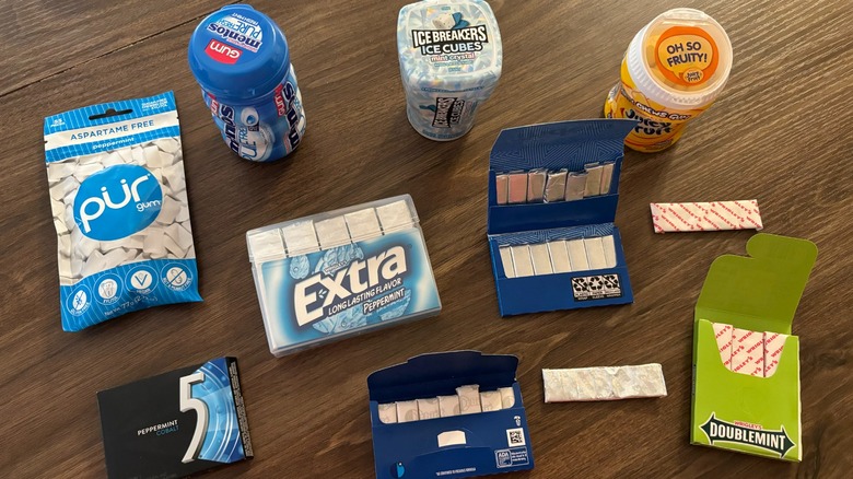 Various gum sticks and gum packages spread out across the table