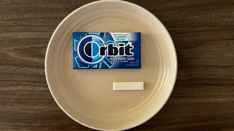 Orbit Gum Peppermint Sugar Free Chewing Gum and pieces of gum on round beige plate
