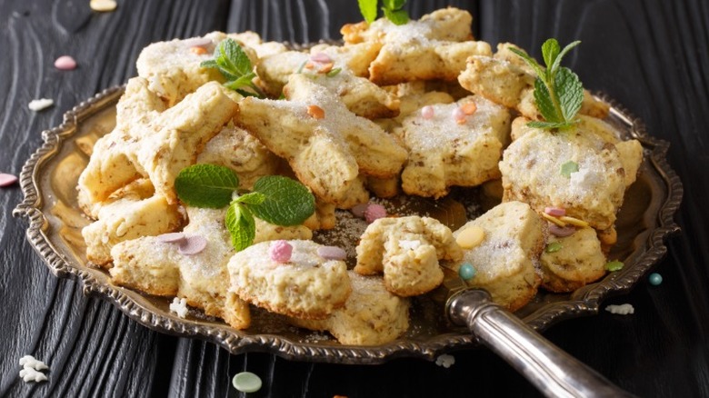 a plate full of Mexican hojarascas, star-shaped cinnamon-sugar coated shortbread cookies