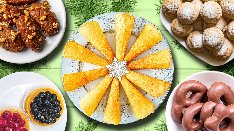 plates of assorted christmas cookies on green background