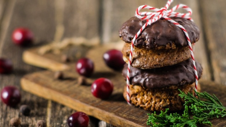 a stack of lebkuchen, german gingerbread cookies, tied with a red and white bow. some covered in chocolate, others with light glaze