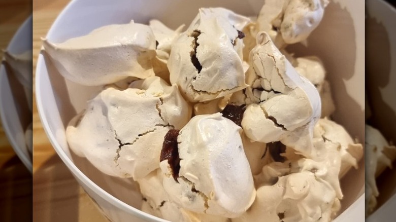 a bowl full of icelandic licorice tops, meringues with chocolate chips and licorice pieces