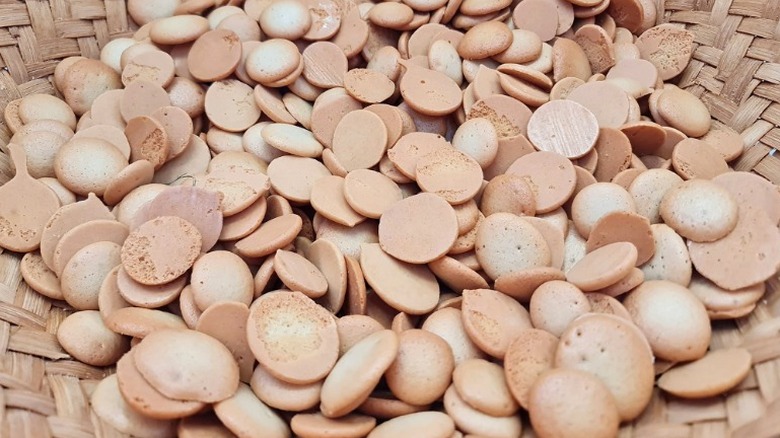 a basket filled with paciencia, small round filipino meringue cookies