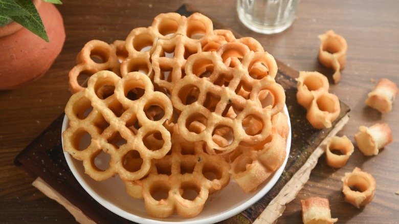 plate of rose cookies, fried fritters from India, on a wooden table
