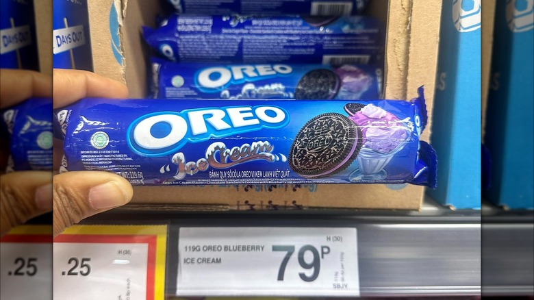 Hand holding sleeve of blueberry ice cream Oreos