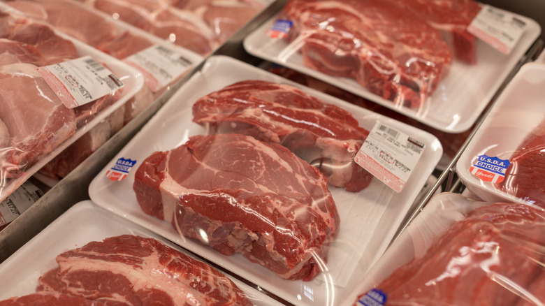Trays of beef steaks wrapped in plastic and on display in Costco meat section