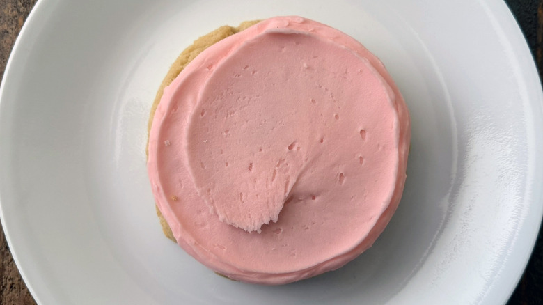 Crumbl's Pink Sugar Cookie on a white plate