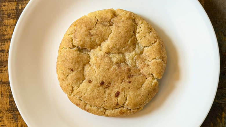 A Crumbl Snickerdoodle Cookie on a white plate