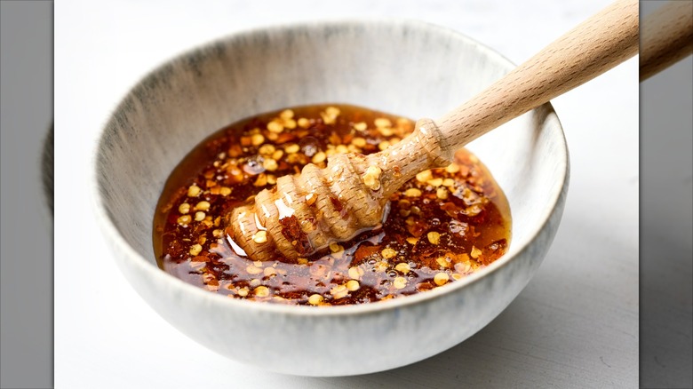 Bowl of hot honey sauce on white kitchen table