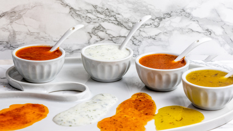 Bowls of four types of salad dressings
