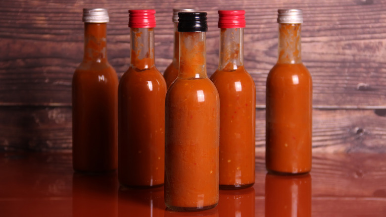 hot sauce bottles in array on surface