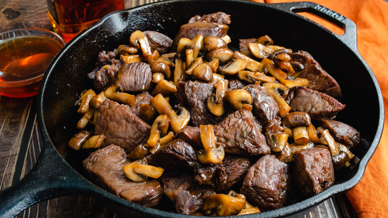 Beef tips and mushrooms in cast iron pan