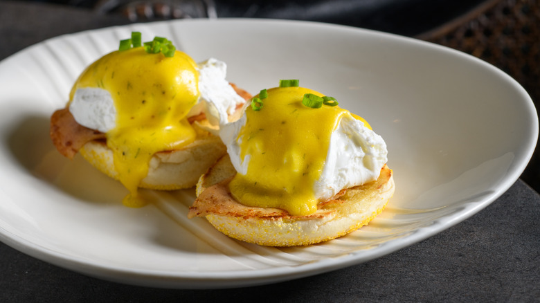 Eggs benedict on white plate