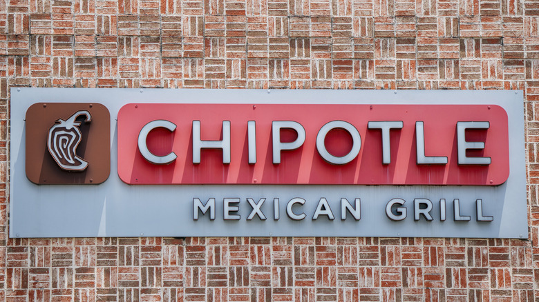 Chipotle sign on brick building