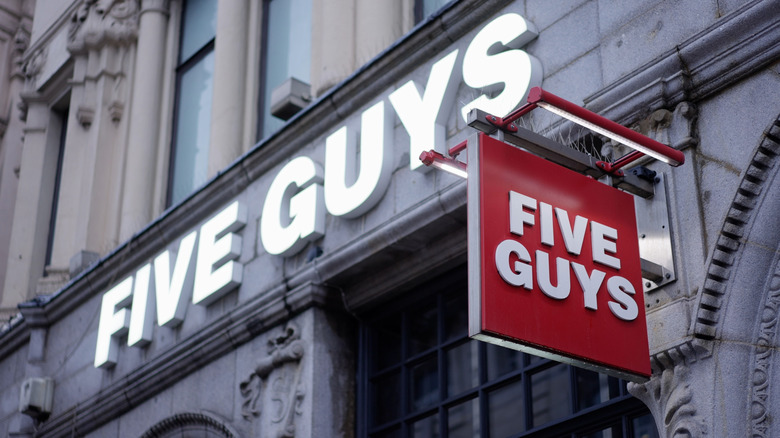 Five Guys storefront with hanging sign