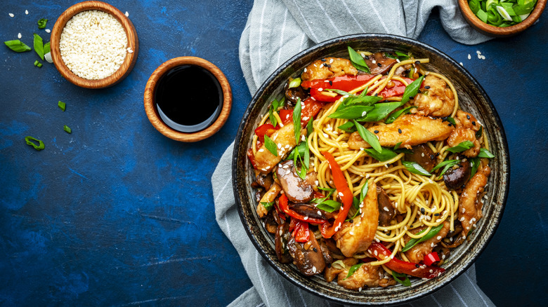 asian dish on black plate with soy sauce in ramekin