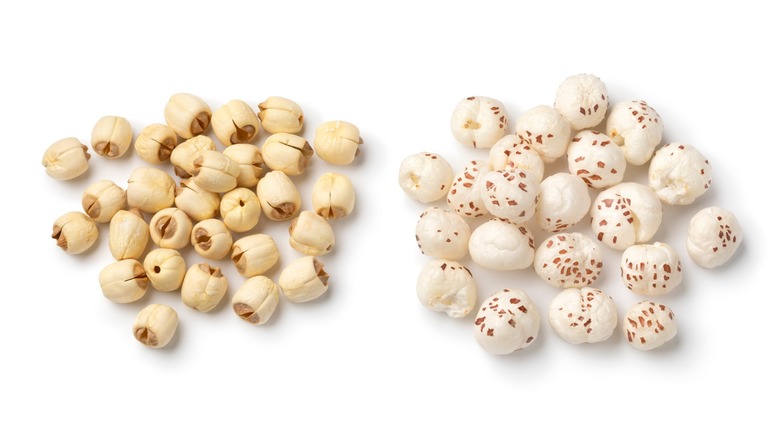 Heap of puffed Lotus seed, Makhana and a heap of dried lotus seed isolated on white background close up
