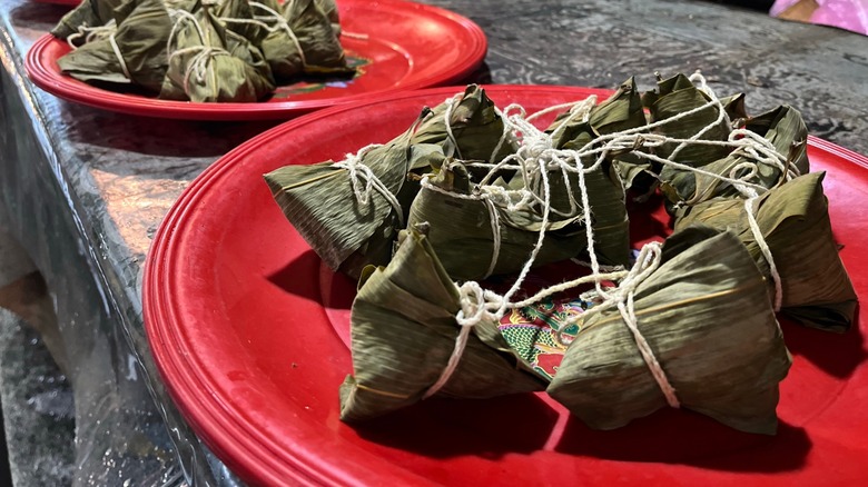 Red plates of zongzi on a long table