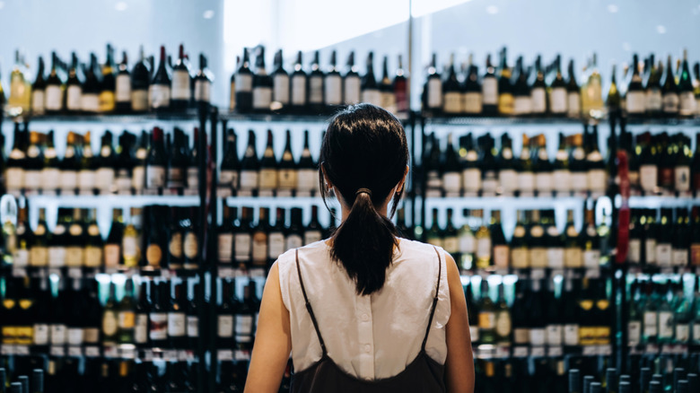 Woman looking at wine in store