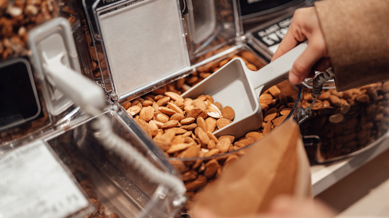 Scooping almonds into bag