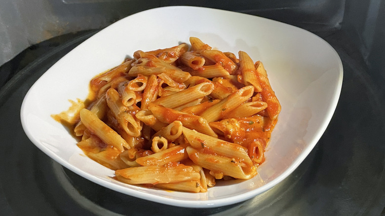 Pasta in microwave on white plate