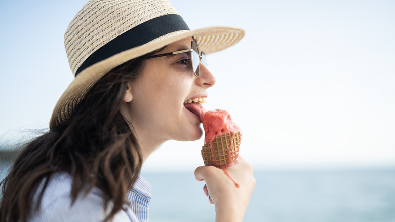 Woman eating sherbet outdoors