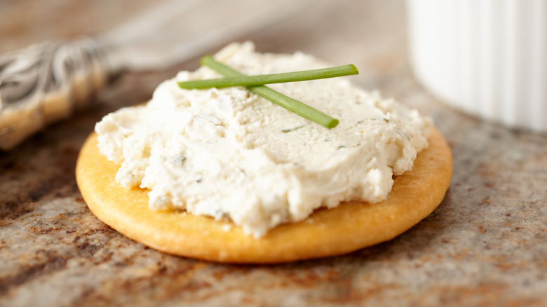spreadable cheese on a cracker