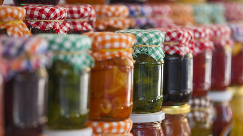 jars of jam with checked cloth lid wrappers
